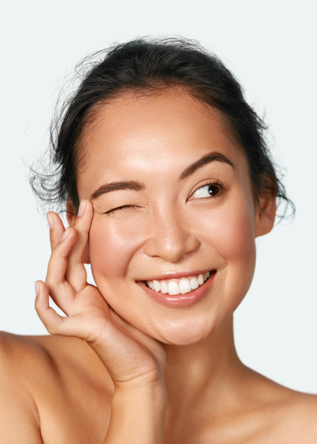 Woman with radiant skin after using AbSonic Glow conductive gel for microcurrent facial treatment