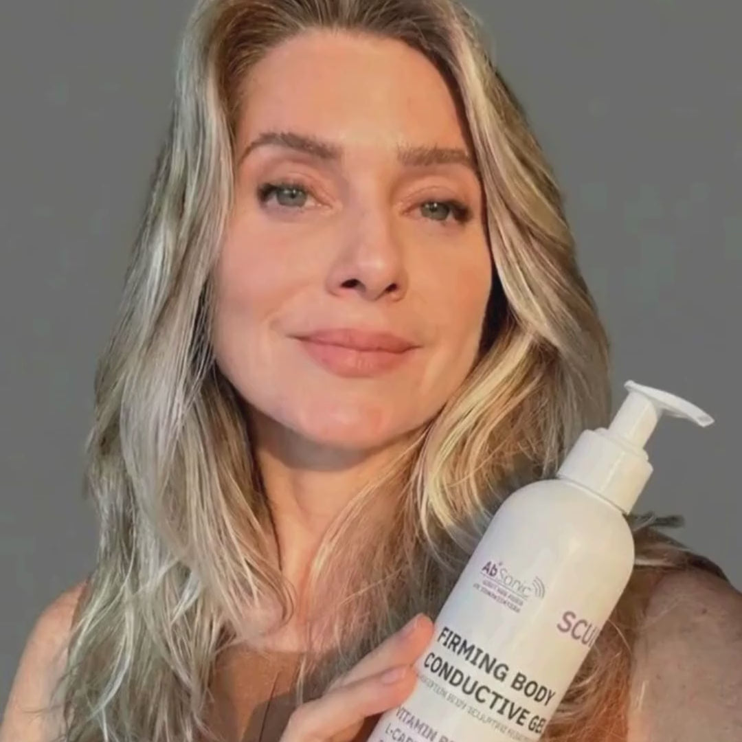 Blonde woman with green eyes and wavy hair speaks directly to camera, holding up a white pump bottle labelled "Absonic Sculpt – Firming Body Conductive Gel." She gestures expressively while talking, with her facial expressions shifting from enthusiastic to engaged to smiling throughout. She wears a brown top against a plain grey background. The video appears to be an AI-generated spokesperson presentation promoting the body firming product.